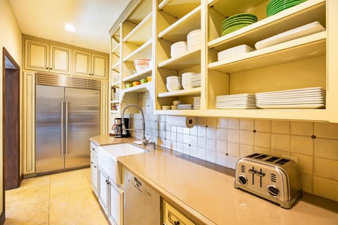 Butler's pantry with SubZero refrigerator/freezer, dishwasher, sink, serviceware