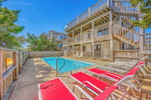 Unwind poolside in your private oasis, where sun-soaked loungers and sparkling water await under clear blue skies.