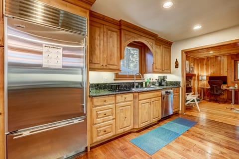 The kitchen is a chef's dream, with oversized fridge, double ovens, countertops