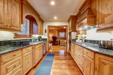 The kitchen is a chef's dream, with oversized fridge, double ovens, countertops
