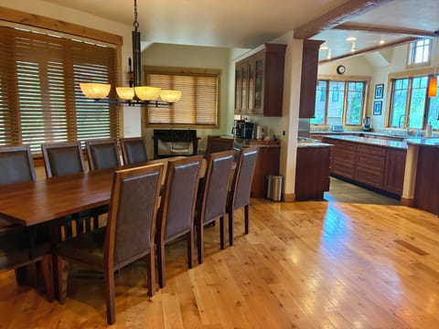 Dining table and chairs (new in 2024) next to kitchen and wet bar