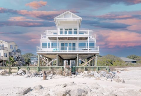 Striking front view of the home against a colorful evening sky