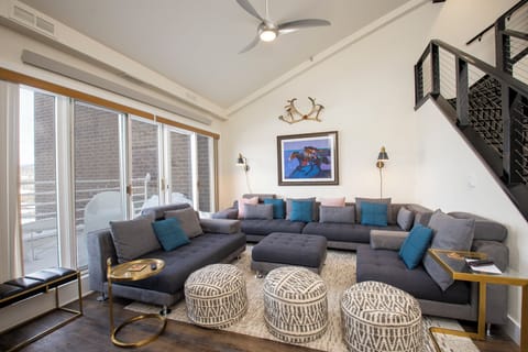 Stretch out on this spacious sectional sofa in your stylish living area, where exposed beams and Southwestern art create a warm, inviting atmosphere.