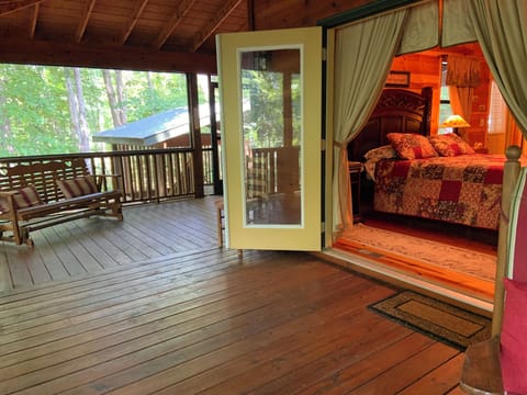 Porch with hot tub gazebo beyond. Generous furnished porches on three sides.