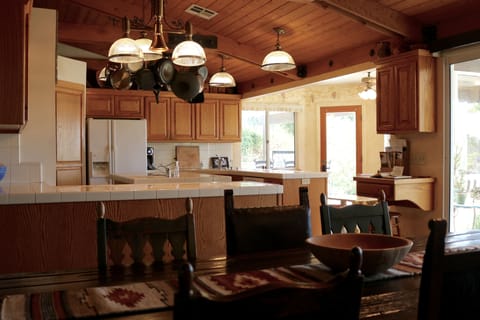 View from dining room to kitchen & breakfast room that has a collapsible buffet