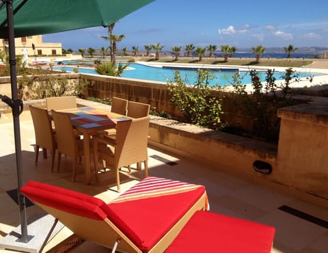 Outdoor furniture in private terrace with views of pool and Mediterranean Sea