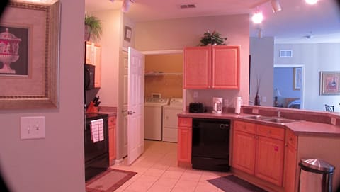 Kitchen area with laundry room behind it