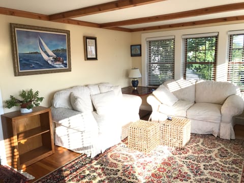 comfy lounge room with a view of the harbor and working water front