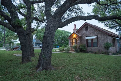 Front of house with oaks trees