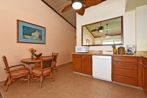 Dining area with kitchenette — enjoy meals in a bright space with seating for four and all essentials.
