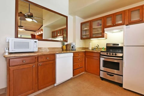 Fully equipped kitchen for easy meals — cook with ease using modern appliances and warm wood cabinetry.