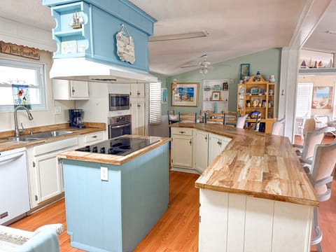 Large open kitchen with large bar top with barstools. All kitchen essentials. 