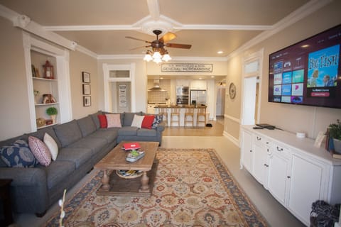 Open concept living room and kitchen. To right is office and left dining room.