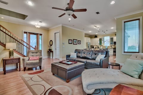 Open concept living space with multiple recliners & leather, queen sleeper sofa.