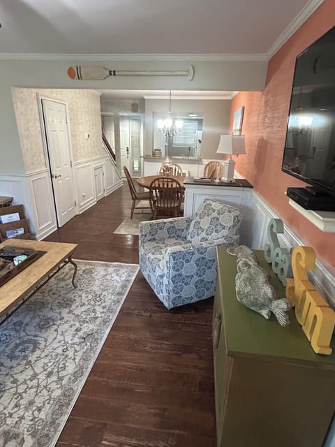 Living room to kitchen with half bath on left
