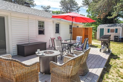 back deck with table chairs and umbrella