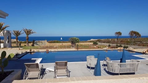 Outdoor pool, open 6:00 AM to midnight, pool umbrellas, sun loungers