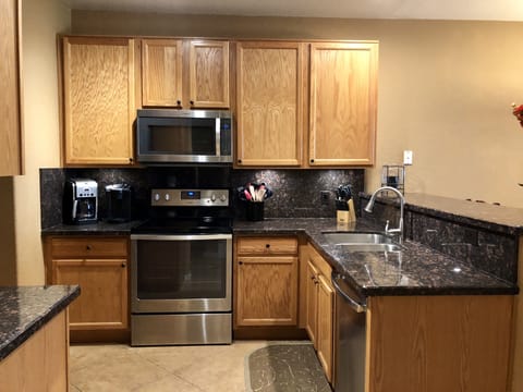 Kitchen is modern and well stocked.