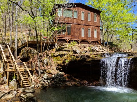 House with stairs to lower deck and your own private waterfall