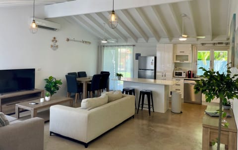 Open plan living and dining area with access to the fenced backyard.