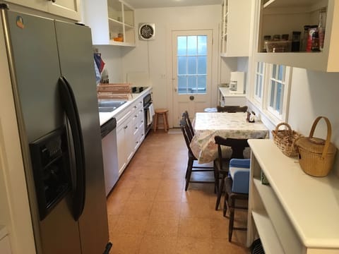 Kitchen with dishwasher, coffee maker, toaster oven, full refrigerator, laundry
