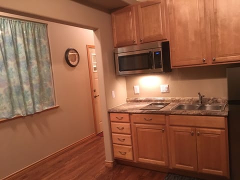Kitchen has stove, microwave, fridge/freezer, crock pot, toaster, pots & pans.