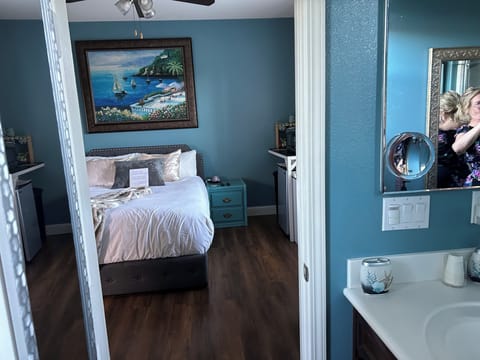 View from the bathroom. The bed linens and towels are white cotton.