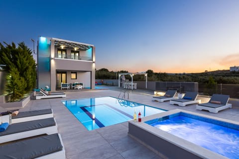The pool terrace and building is beautifully lit at night!