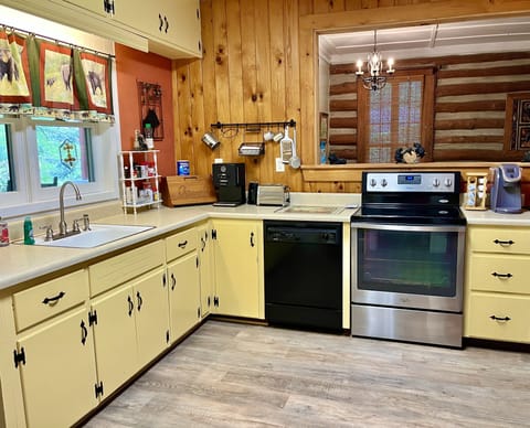 Kitchen with upgraded appliances, pots, pans, utensils and dinnerware