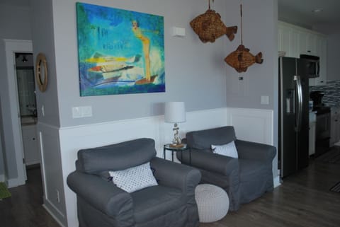 Reading chairs look out toward the beach or to the flat screen television.