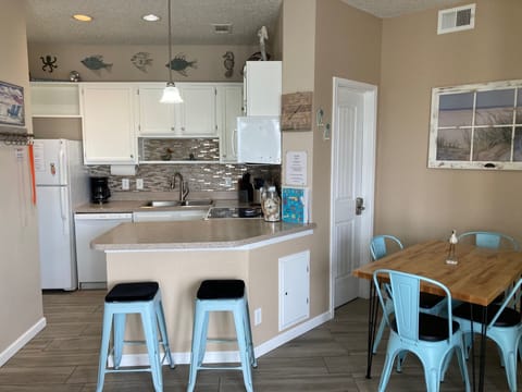 Open kitchen flowing into dining area and living area