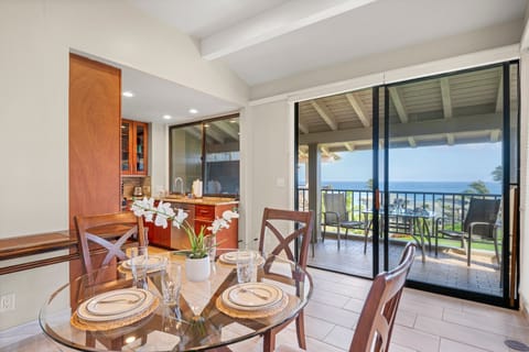 Open-concept living area seamlessly connecting the living room, kitchen, and lanai with ocean views
