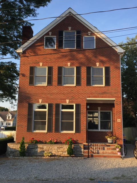 All brick, three story house with parking for 5 cars. 