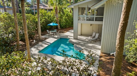 Private pool area with several loungers and outdoor dining table.  Grill is around the corner.