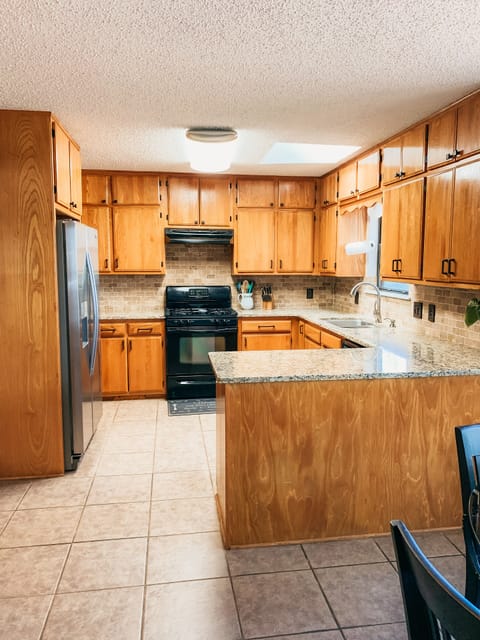 Kitchen with granite counters. Gas stove