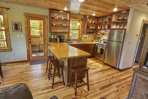 Three bar stools around the butcher block counter top provide extra seating.