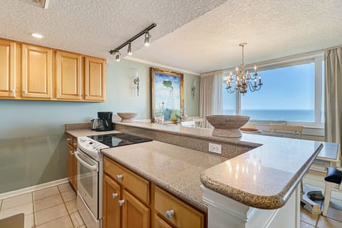 Fully Equipped Kitchen with Stainless Steel Appliances and a View to Enjoy While Cooking