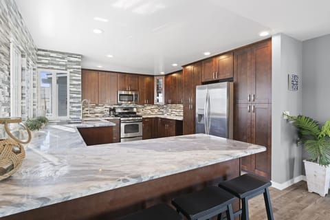 Barstool seating provides front row seats to snack and meal prep in the kitchen headquarters.
                