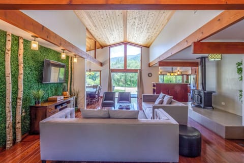 Living room area with Cathedral Windows offer spectacular views of Denison Peak.