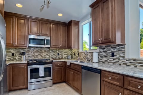 Brand new kitchen featuring granite countertops and stainless steel appliances