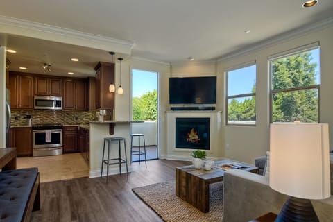 View of living room, kitchen, and 2nd floor balcony
