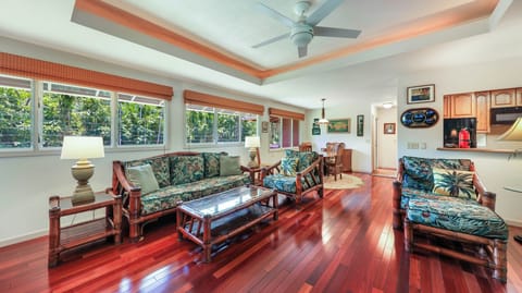 The living room/dining area with 30's Hawaiian art and Tommy Bahama furniture.