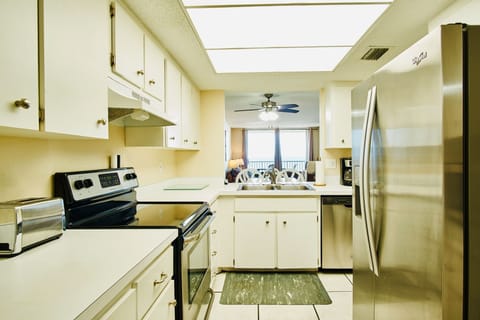 Kitchen fully stocked with utensils overlooking the ocean 