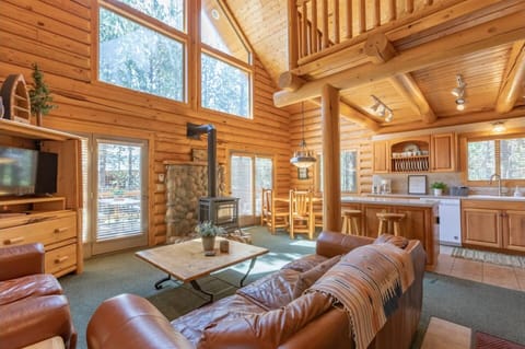 The cozy charm of the rustic cabin, featuring natural wood accents and a warm ambiance, evokes a sense of comfort and relaxation.