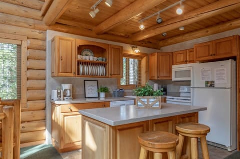 From the sturdy wooden walls to the natural finish of the cabinets, every detail exudes warmth and simplicity