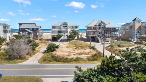 A luxurious beachfront home, offering unparalleled access to the sand and surf for the ultimate coastal living experience.