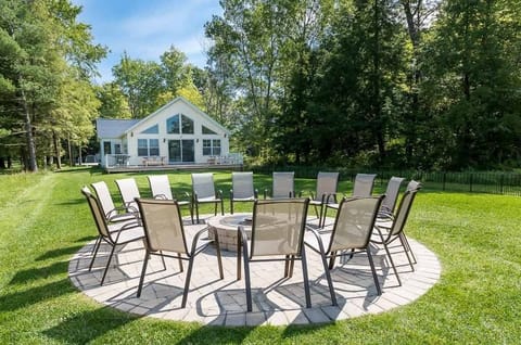 Sunset Shores Lake House fire pit with chairs, as viewed from the private beach
