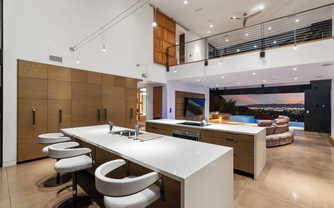 Unwind in this bright, open living space with plush seating and a sleek kitchen.