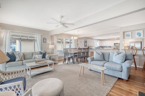 When you enter the home, you are welcome by an open concept living area which includes a dining table for 8, a breakfast bar, full kitchen and living room with plenty of seating.