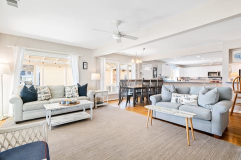 The living room offers 2 comfortable couches, 2 additional chairs, smart tv and sliding glass doors to access the beach side porch.